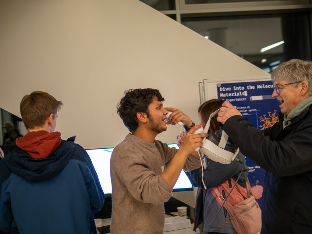 A visitor is testing the VR headset at the PULS booth.