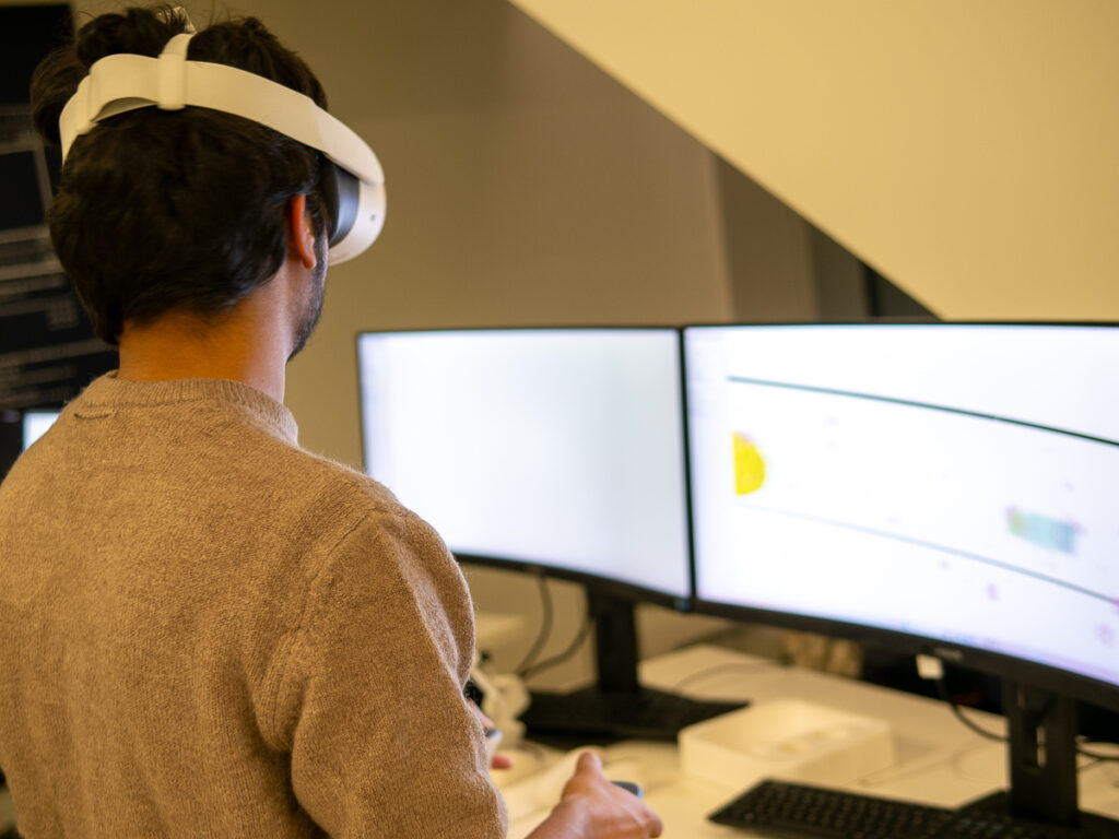 A researcher is setting up the VR head set.